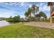 Brick patio overlooks the canal, offering water views and lush landscaping at 135 Tina Island Dr, Osprey, FL 34229