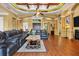 Living room with hardwood floors, coffered ceiling, and leather sofas at 135 Tina Island Dr, Osprey, FL 34229