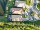 Aerial view of two homes with tile roofs and screened lanais at 13912 Rinuccio St, Venice, FL 34293