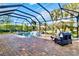 Relaxing pool and patio area with a covered seating area at 13912 Rinuccio St, Venice, FL 34293