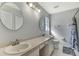 Clean bathroom with double vanity and shower at 143 Swan Dr, Rotonda West, FL 33947