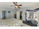 Bright bedroom with ceiling fan and access to patio at 143 Swan Dr, Rotonda West, FL 33947