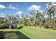 Landscaped backyard with lush tropical vegetation at 169 N Cayman Isles Blvd, Englewood, FL 34223