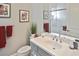 Bathroom showcasing vanity, mirror, adjacent toilet and tiled shower with glass door at 169 N Cayman Isles Blvd, Englewood, FL 34223