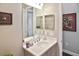 Clean bathroom featuring a framed mirror, a vanity, and simple decor at 169 N Cayman Isles Blvd, Englewood, FL 34223