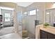 Stylish bathroom featuring a marble shower with glass enclosure and a walk-in closet at 169 N Cayman Isles Blvd, Englewood, FL 34223