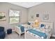 Guest bedroom with two twin beds, window, and coastal decor at 169 N Cayman Isles Blvd, Englewood, FL 34223