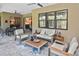 Cozy covered patio with seating area, ceiling fan, and view of the outdoor space at 169 N Cayman Isles Blvd, Englewood, FL 34223