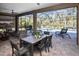 Inviting outdoor patio with dining set overlooking a screened pool and lush landscaping at 169 N Cayman Isles Blvd, Englewood, FL 34223