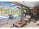 Relaxing covered patio with comfortable seating area and view of the screened pool at 169 N Cayman Isles Blvd, Englewood, FL 34223