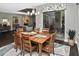 The dining room with a wooden table is open to the living room and has a view of the patio at 169 N Cayman Isles Blvd, Englewood, FL 34223