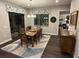 The dining room has a wooden table, a large patterned rug, and sliding glass doors to the outside at 169 N Cayman Isles Blvd, Englewood, FL 34223