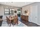 The dining room has a wooden table, a patterned rug, and a cabinet against the wall at 169 N Cayman Isles Blvd, Englewood, FL 34223