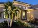 Inviting front entrance with palm trees and outdoor seating at 169 N Cayman Isles Blvd, Englewood, FL 34223