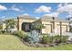 Beautiful single-Gathering home featuring a three-car garage, manicured landscaping, and a tile roof at 169 N Cayman Isles Blvd, Englewood, FL 34223