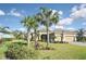 Two-story house with palm trees and manicured landscaping at 169 N Cayman Isles Blvd, Englewood, FL 34223