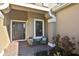 Charming front porch with comfortable seating, brick pavers, and a stylish entrance at 169 N Cayman Isles Blvd, Englewood, FL 34223