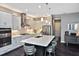 Bright kitchen boasts white cabinets, stainless steel appliances, and a spacious island with seating at 169 N Cayman Isles Blvd, Englewood, FL 34223