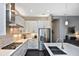 This modern kitchen features stainless appliances, white cabinets, and stone countertops with eat-in breakfast bar at 169 N Cayman Isles Blvd, Englewood, FL 34223