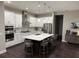 Well-appointed kitchen featuring sleek countertops, stainless steel appliances, and an island with bar stools at 169 N Cayman Isles Blvd, Englewood, FL 34223