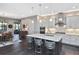 Modern kitchen with white cabinets, large island, stainless steel appliances, and quartz countertops at 169 N Cayman Isles Blvd, Englewood, FL 34223