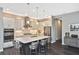 Modern kitchen featuring white cabinets, stainless steel appliances, and an island with seating at 169 N Cayman Isles Blvd, Englewood, FL 34223