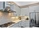 This modern kitchen features stainless appliances, white cabinets, and stone countertops at 169 N Cayman Isles Blvd, Englewood, FL 34223