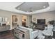 Open-concept living room with tray ceiling, modern decor, and seamless flow to other spaces at 169 N Cayman Isles Blvd, Englewood, FL 34223