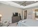 Comfortable main bedroom features a ceiling fan and large windows overlooking the yard at 169 N Cayman Isles Blvd, Englewood, FL 34223
