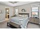 Main bedroom with king-size bed, ensuite bathroom access, and neutral decor at 169 N Cayman Isles Blvd, Englewood, FL 34223