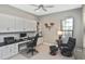 Office with built-in desk and cabinets, a window with blinds, and a black leather chair at 169 N Cayman Isles Blvd, Englewood, FL 34223