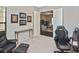 Comfortable office space with neutral tones, gaming chair, and view into the living area at 169 N Cayman Isles Blvd, Englewood, FL 34223