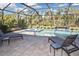 Screened pool area with lounge chairs, creating a perfect outdoor retreat at 169 N Cayman Isles Blvd, Englewood, FL 34223