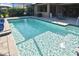 Backyard screened pool with aqua water and brick trim invites sun-soaked relaxation at 169 N Cayman Isles Blvd, Englewood, FL 34223