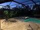 Night view of the relaxing screened pool and spa at 169 N Cayman Isles Blvd, Englewood, FL 34223