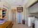 Functional laundry room with cabinets and desk space at 1705 Meadowlark Ln, Englewood, FL 34224