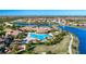 Aerial view of community with pool, clubhouse and surrounding landscape at 20049 Benissimo Dr, Venice, FL 34293