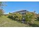 Landscaped backyard featuring lush tropical plants and pool enclosure at 20329 Concerto Pl, Venice, FL 34293