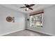 Cozy spare bedroom with large window and ceiling fan at 2228 Terracina Dr, Venice, FL 34292