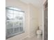 Clean bathroom with shower, toilet, and arched window at 229 Venice Palms Blvd, Venice, FL 34292