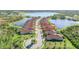 Aerial view of a luxury home community with lake access and lush landscaping at 24029 Canterwood Way, Venice, FL 34293