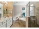 Elegant bathroom with double vanity, soaking tub, and shower at 24029 Canterwood Way, Venice, FL 34293