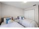 Well-lit bedroom featuring two twin beds, nightstands, and built-in closet at 3015 Seawind Cir # 12A, Venice, FL 34293