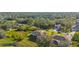 Aerial view of homes nestled in a quiet neighborhood with mature trees at 4467 Cinderella Cir, North Port, FL 34286