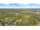 Wide aerial view of a suburban neighborhood near a highway and lake at 4467 Cinderella Cir, North Port, FL 34286