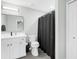 Modern bathroom with white vanity and grey tile floor at 4467 Cinderella Cir, North Port, FL 34286