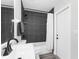 Modern bathroom with dark grey tile, white vanity, and a bathtub at 4467 Cinderella Cir, North Port, FL 34286