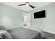 Bedroom with green walls, ceiling fan, and mounted TV at 4467 Cinderella Cir, North Port, FL 34286