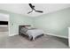 Bedroom with green walls, ceiling fan and view into living area at 4467 Cinderella Cir, North Port, FL 34286