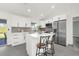 Modern kitchen with white cabinets, quartz countertops, and stainless steel appliances at 4467 Cinderella Cir, North Port, FL 34286